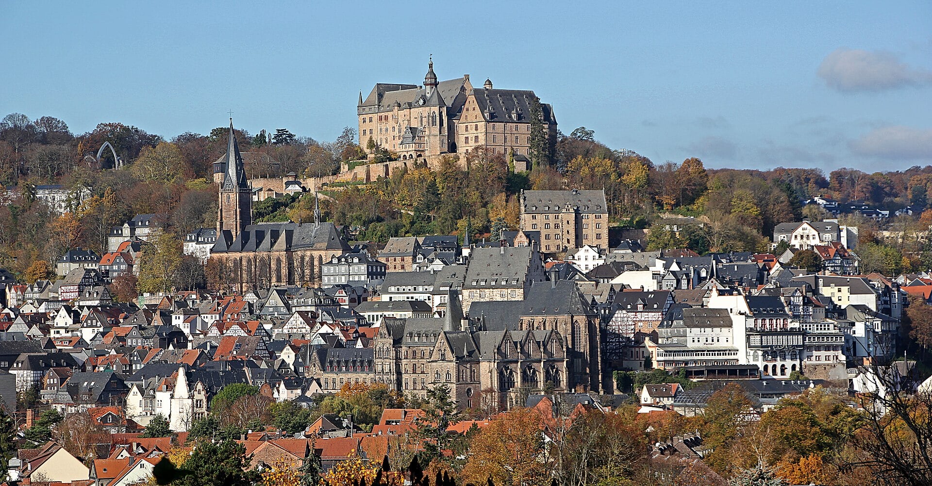 The old town of Marburg climbing a hill toward the castle, with church spires among the rooftops